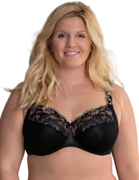 Woman wearing an Anita Rosa Faia black bra with lace details against a white background