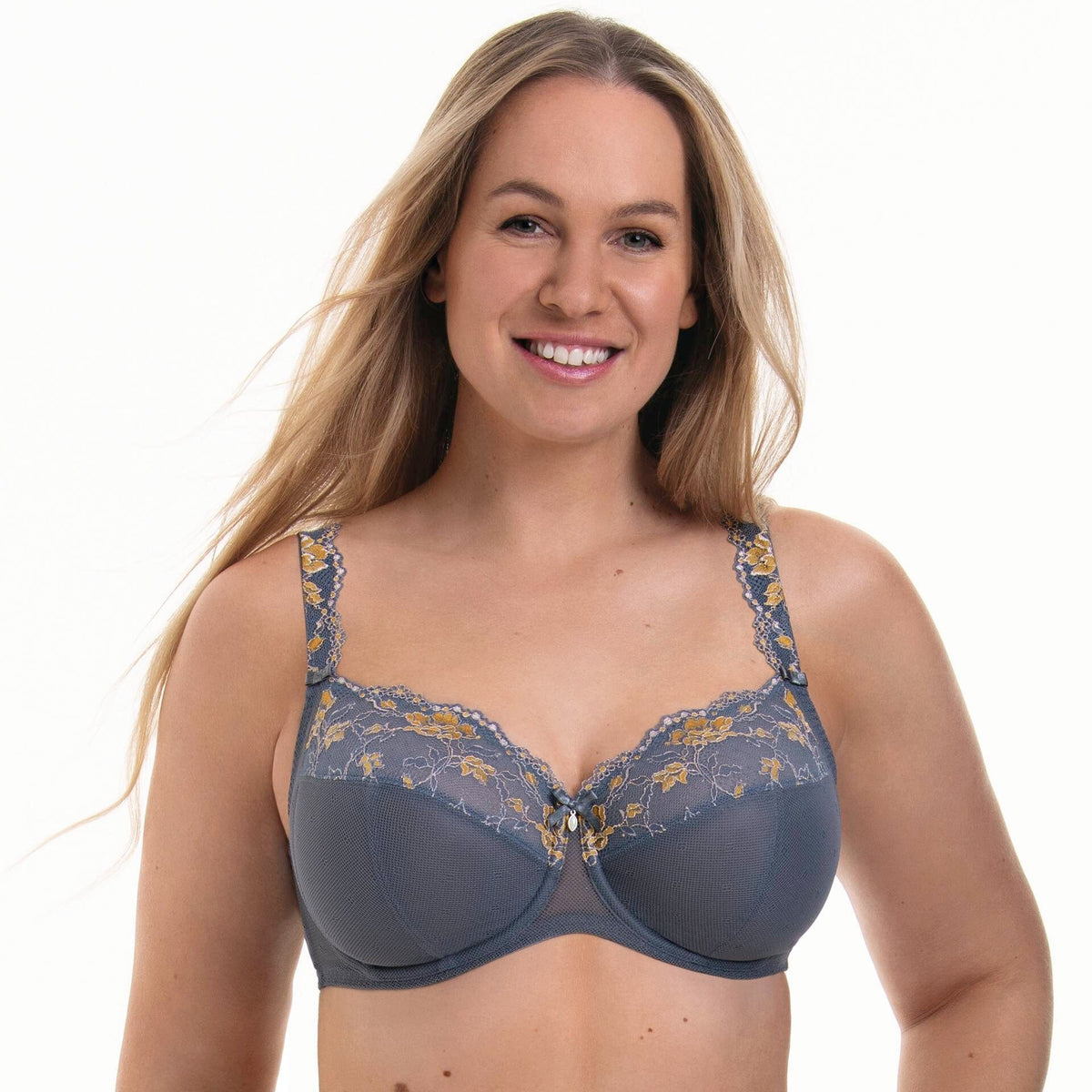 Woman wearing an anita Rosa Faia Full Cup Grey Bra Colette with floral lace details on a white background