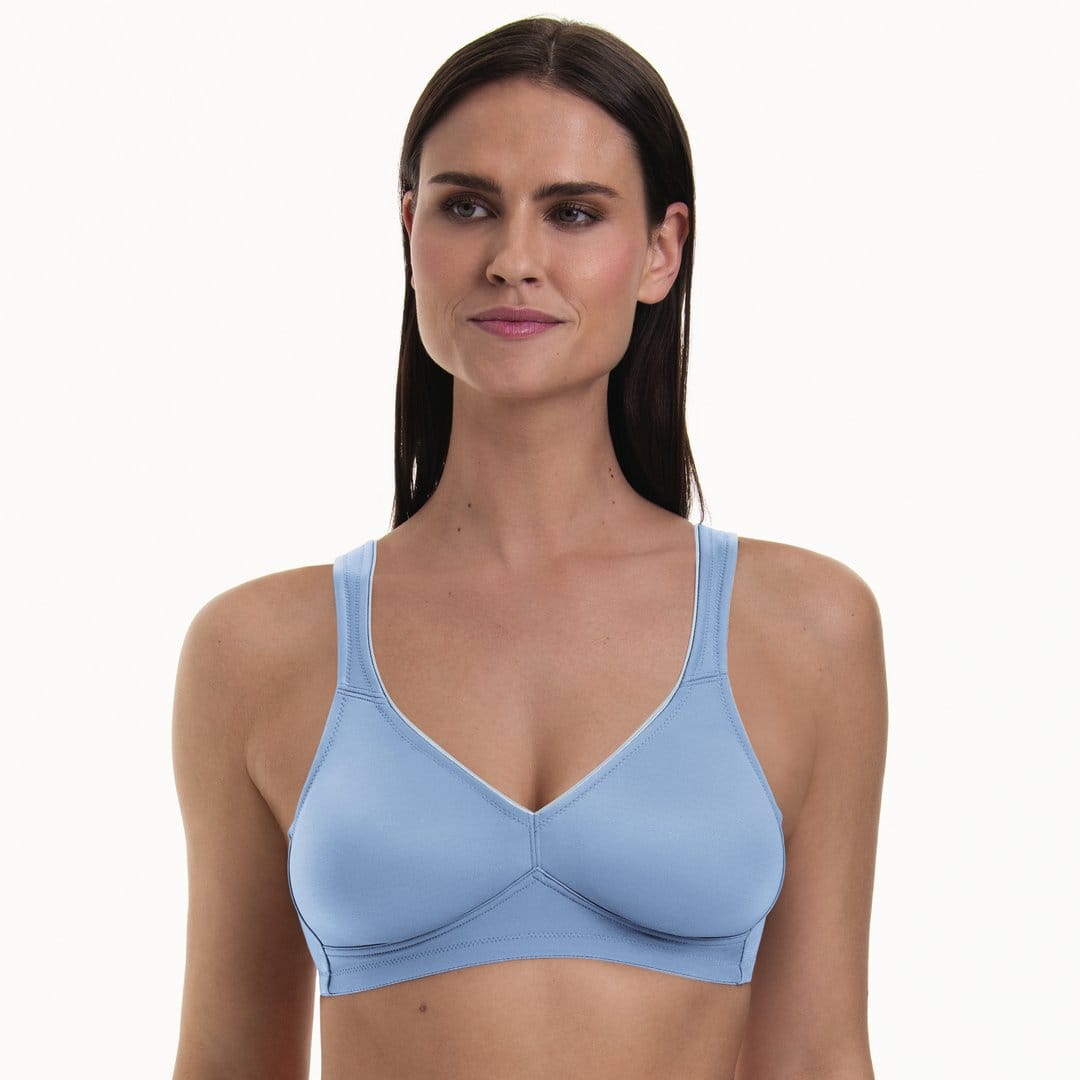 Woman wearing an Anita light blue seamless t shirt bra on a white background