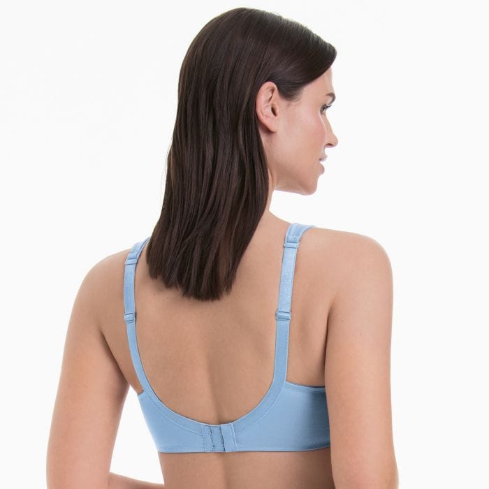 A woman shown from the back wearing a light blue bra, photographed against a clean white studio background.
