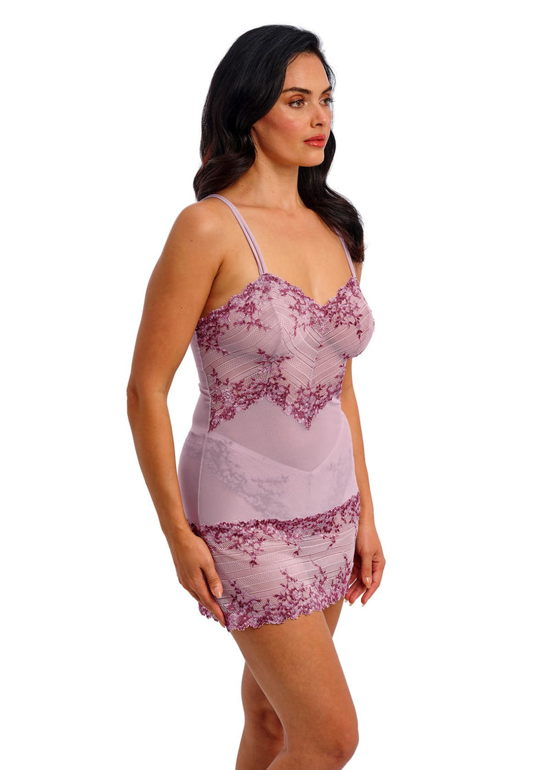 Woman wearing a pink lace nightgown on a white background